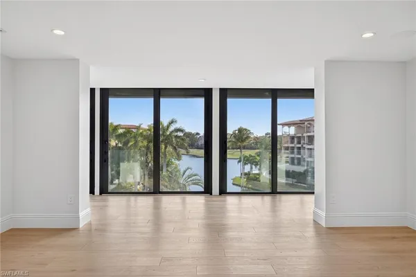 wooden floor in an empty room with large windows