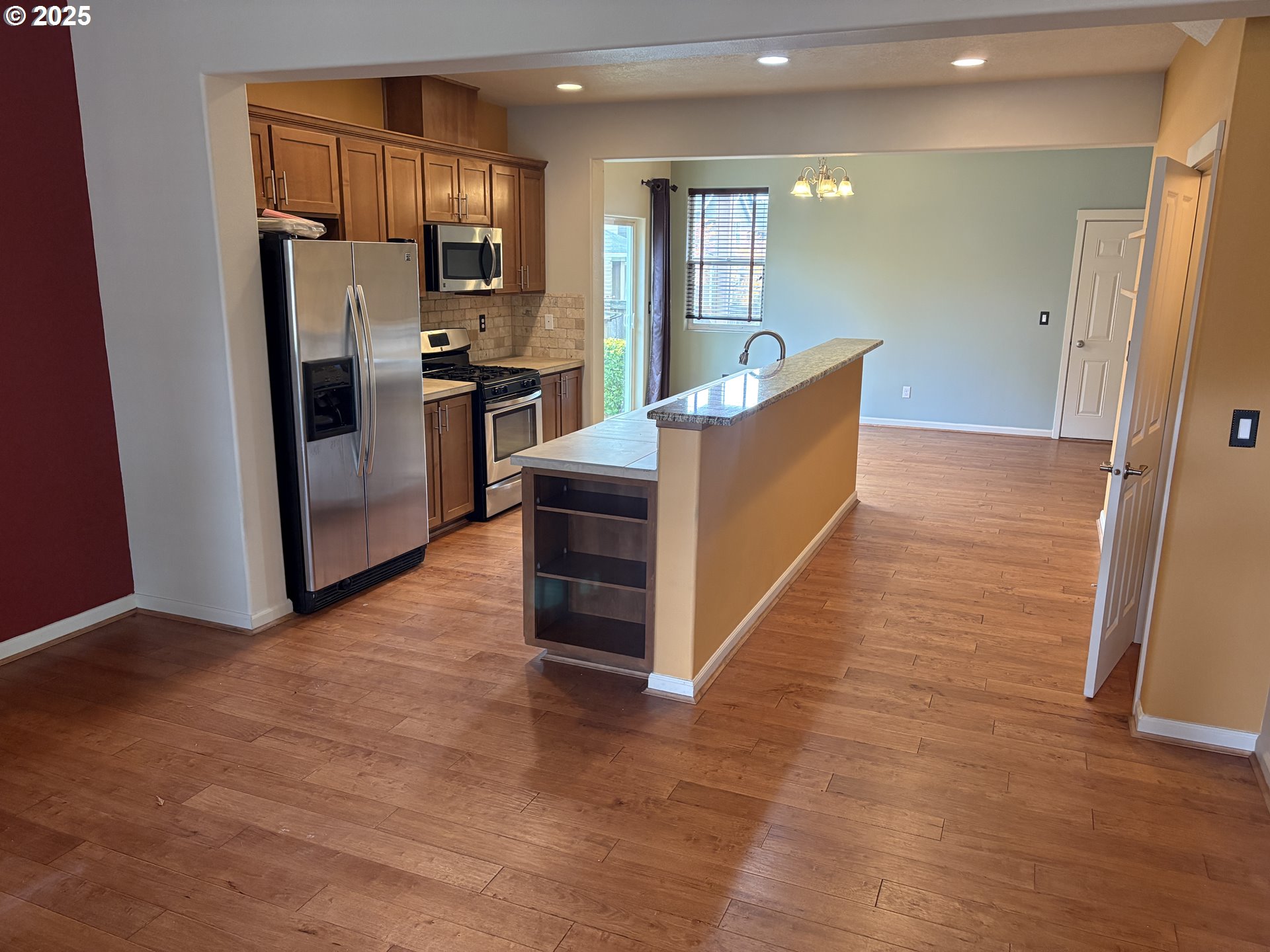 10552 Northeast Gateway Street Hillsboro, OR 97006 - Photo 5 of 41 a kitchen with stainless steel appliances granite countertop a refrigerator and a stove