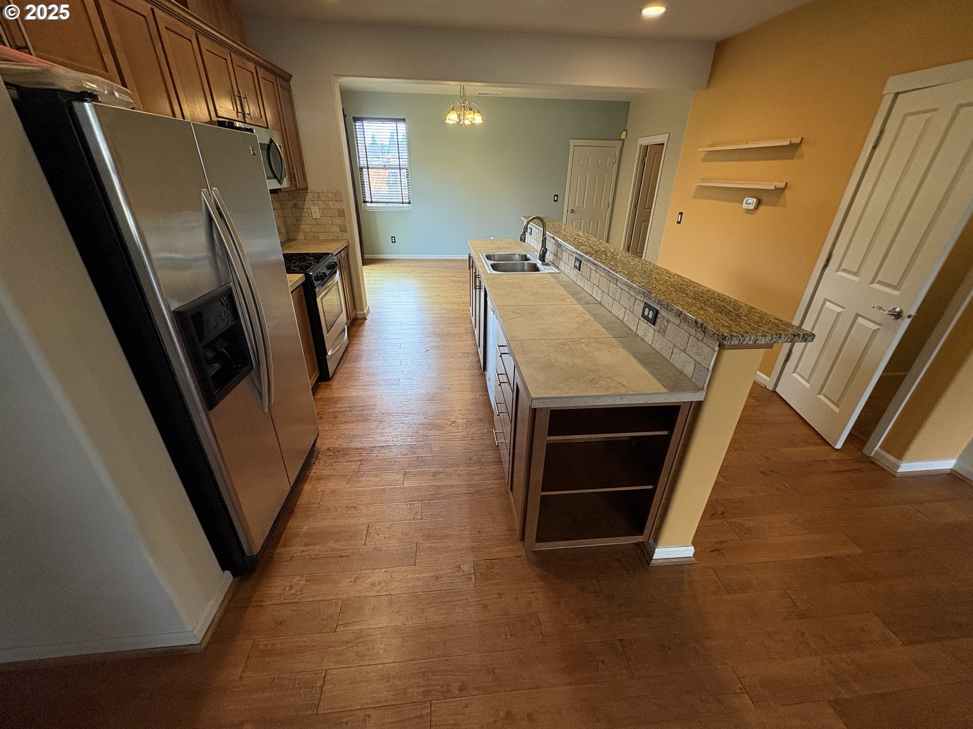 10552 Northeast Gateway Street Hillsboro, OR 97006 - Photo 6 of 41 a view of an empty room with wooden floor and a fire place