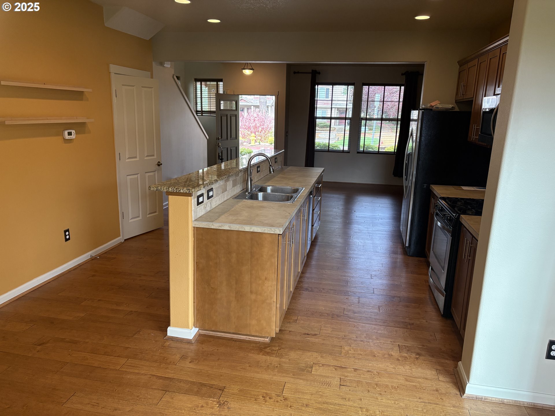 10552 Northeast Gateway Street Hillsboro, OR 97006 - Photo 7 of 41 a hall with wooden floor and cabinets