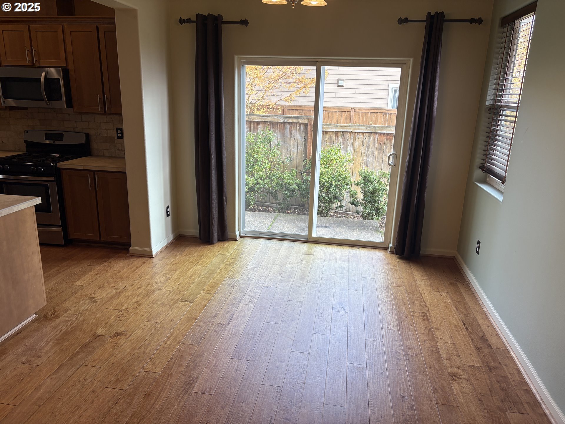 10552 Northeast Gateway Street Hillsboro, OR 97006 - Photo 10 of 41 a view of a kitchen with wooden floor and a window