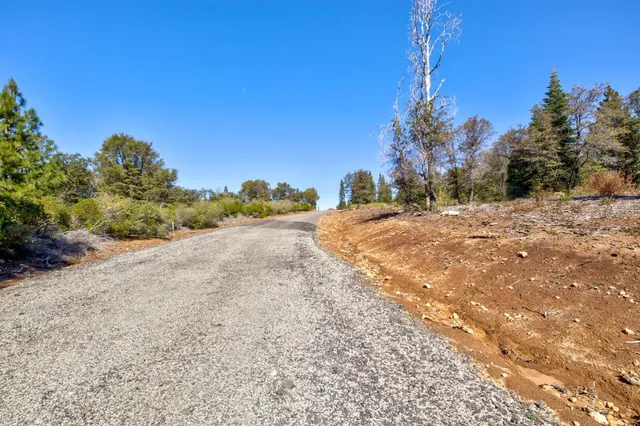 a view of a dirt road and a building