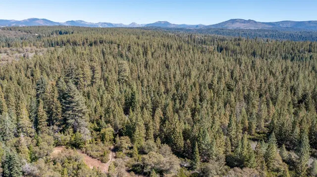 a view of mountain with sunset in background
