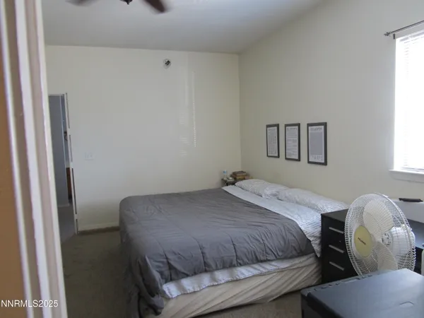 a bedroom with a bed and window