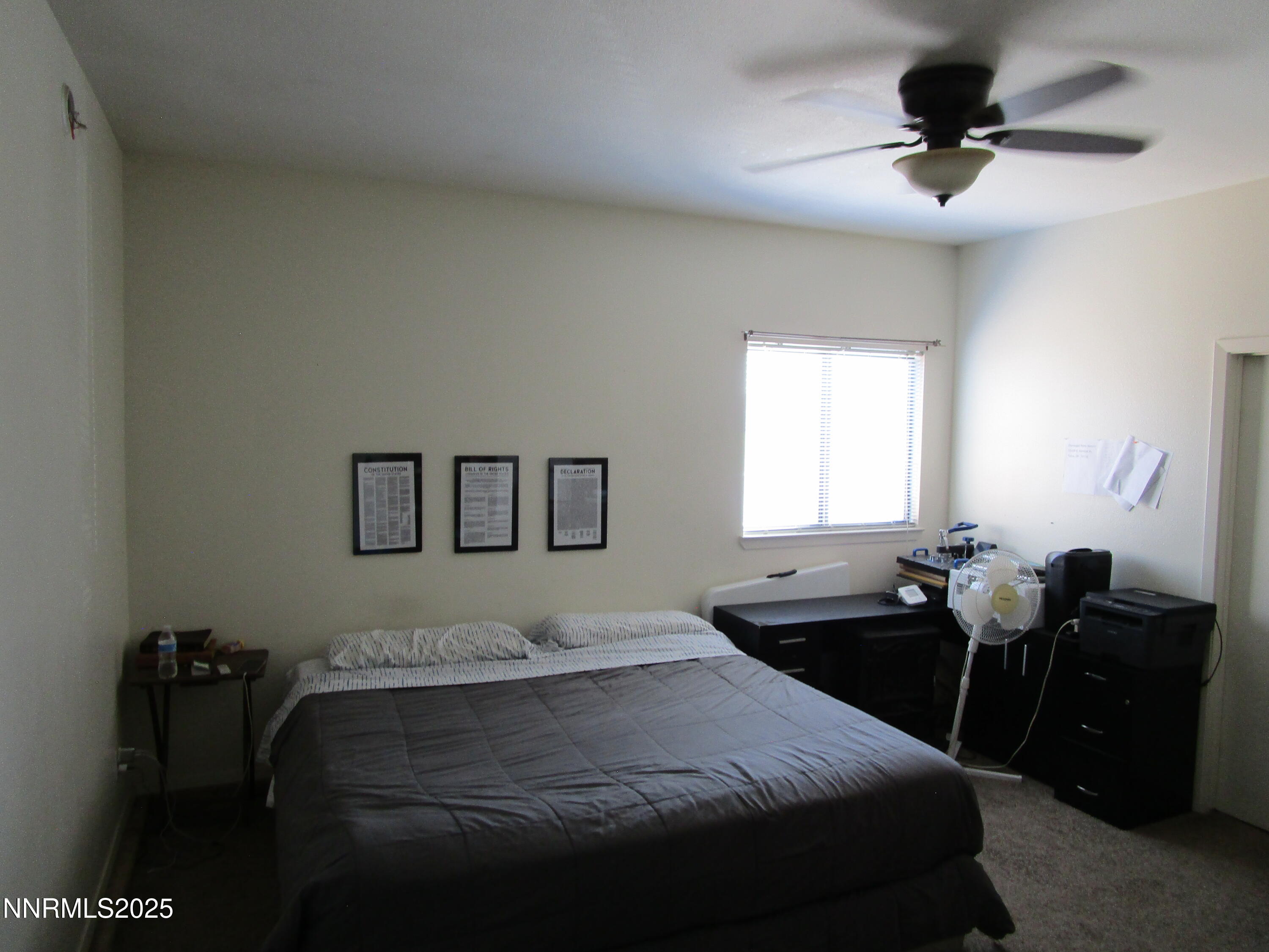 1091 Tiffany Drive Fallon, NV 89406 - Photo 14 of 31 a bedroom with a bed and a chandelier