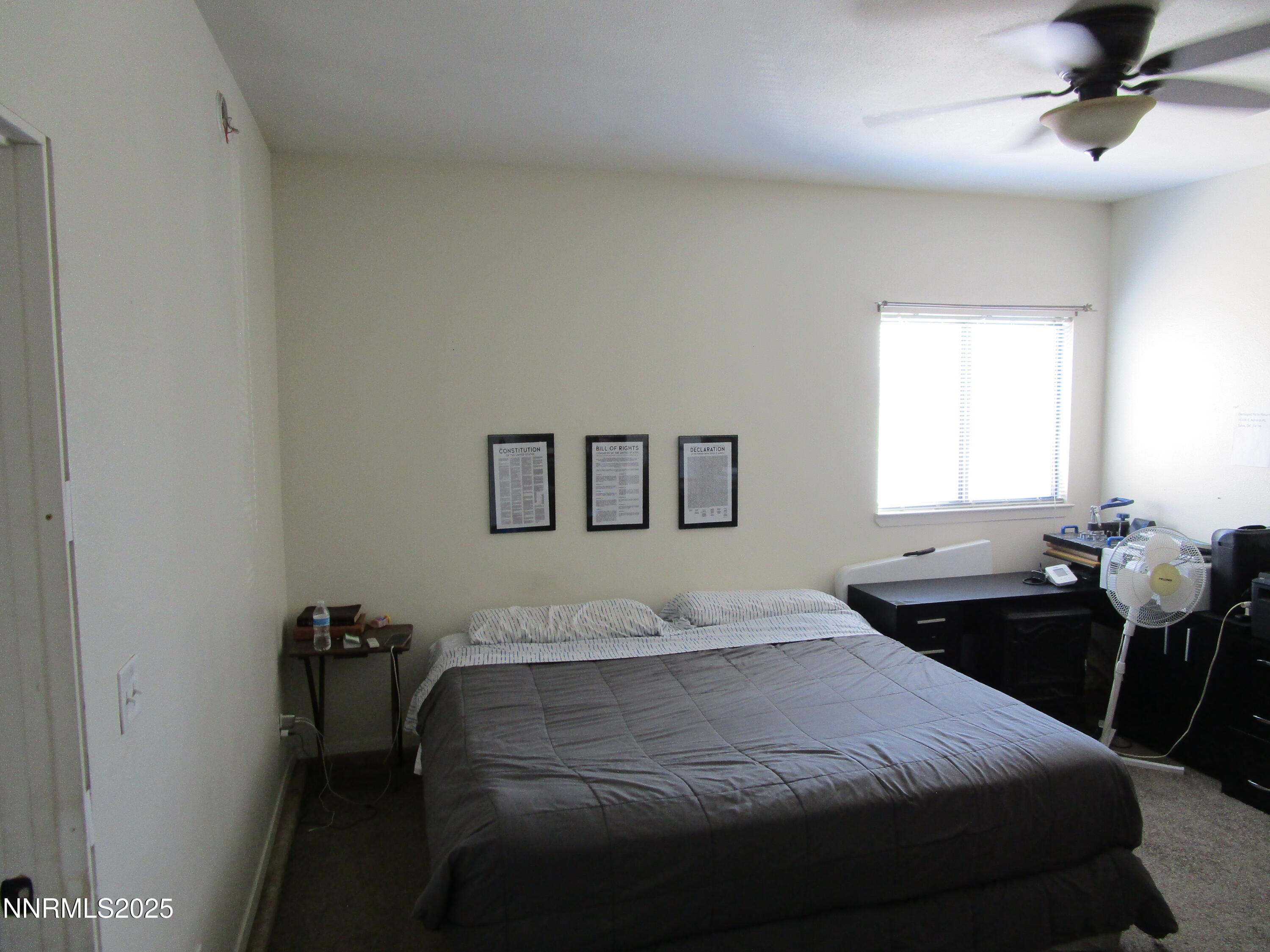 1091 Tiffany Drive Fallon, NV 89406 - Photo 18 of 31 a bedroom with a bed and wooden floor