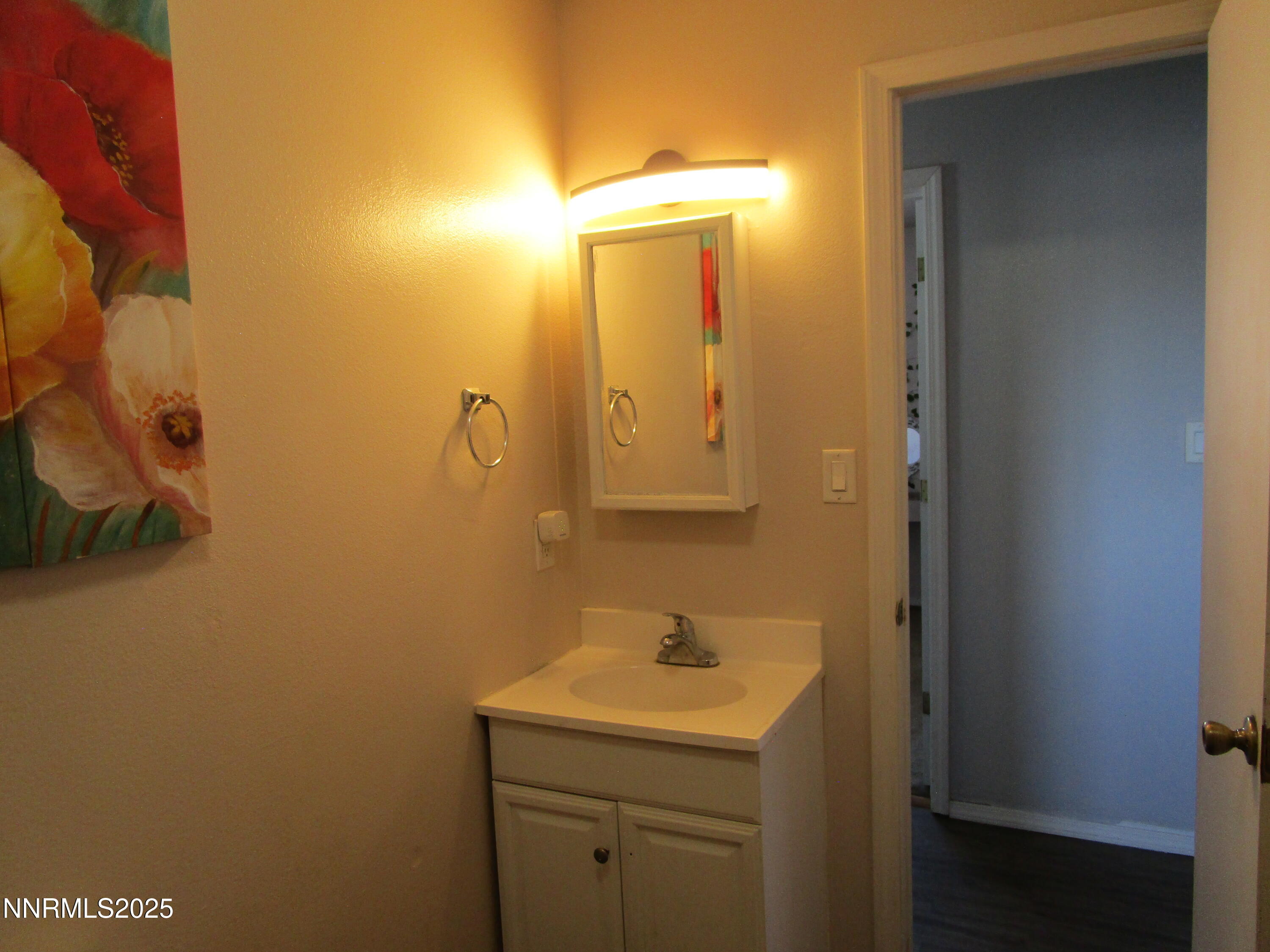 1091 Tiffany Drive Fallon, NV 89406 - Photo 24 of 31 a bathroom with a sink a toilet and mirror