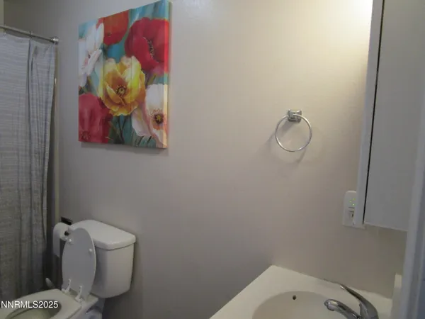 a bathroom with a toilet and shower