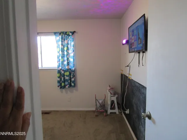 a view of a hallway with workspace and a window