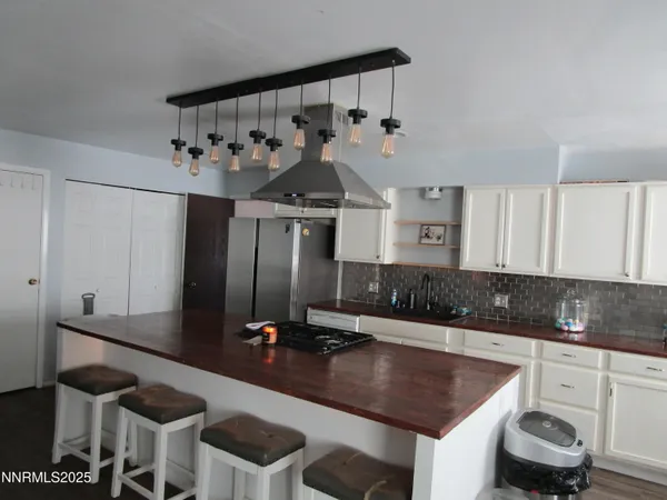 a kitchen with a table chairs stove and cabinets