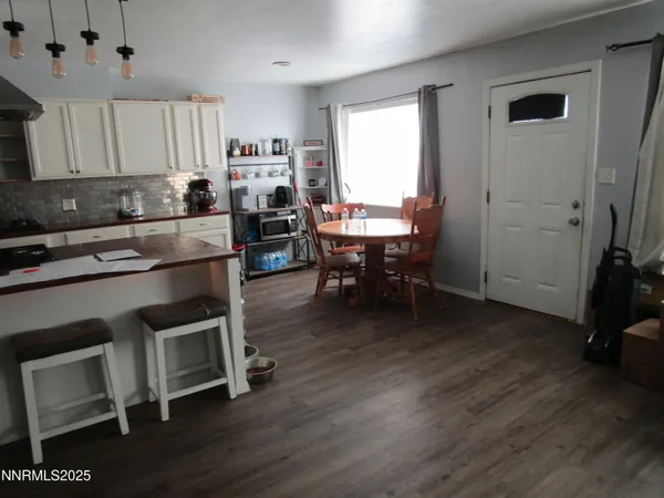 a view of kitchen with cabinets and wooden floor
