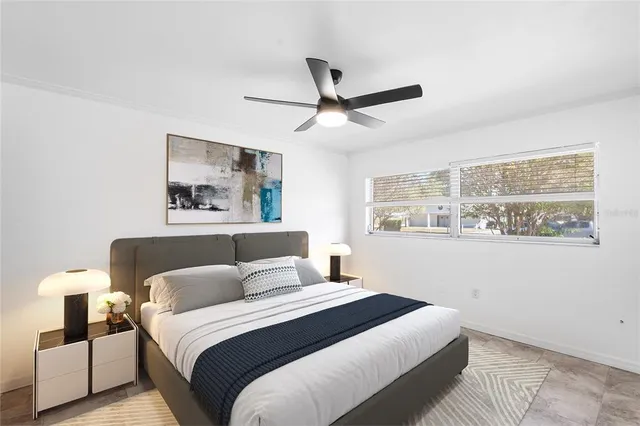 a bedroom with a large bed and a window