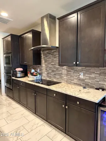 a kitchen with stainless steel appliances granite countertop wooden cabinets and a sink