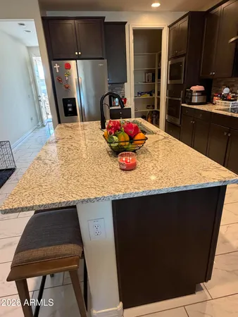 a kitchen with kitchen island a sink dishwasher stove and refrigerator