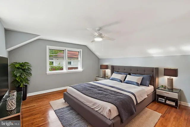 a bedroom with a bed and a potted plant