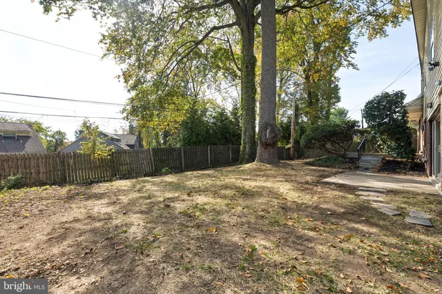 a backyard of a house with a trees