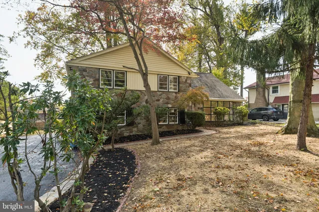 a view of a house with a yard covered in snow