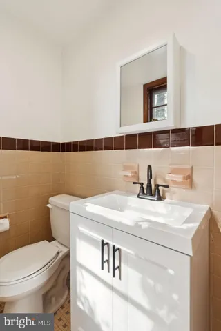 a bathroom with a sink a toilet and mirror