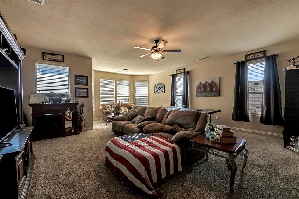 3206 Meadow Ridge Drive Midlothian, TX 76065 - Photo 30 of 37 a living room with a couch and a flat screen tv
