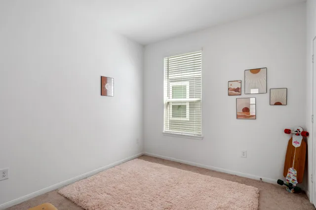 a view of a room with gym equipment and a window