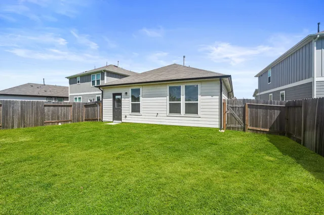 a view of a house with yard and front view of a house
