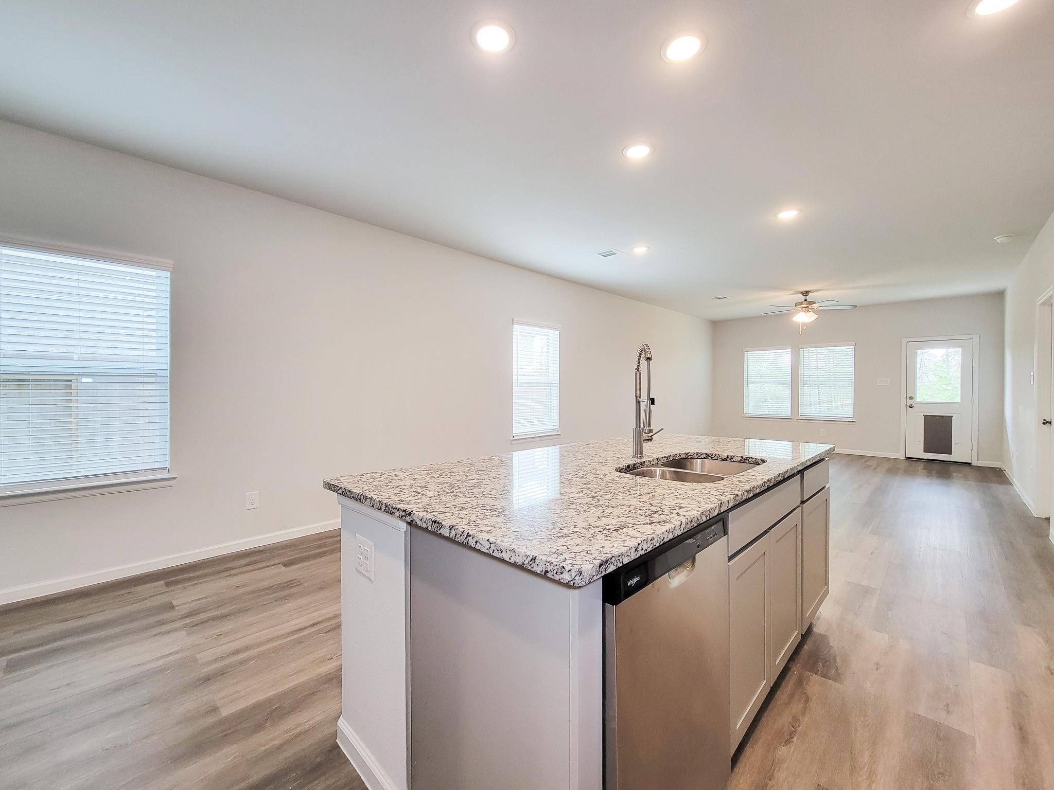 94 Valiant Ridge Trail Magnolia, TX 77354 - Photo 18 of 47 a kitchen with stainless steel appliances granite countertop a sink stove and cabinets