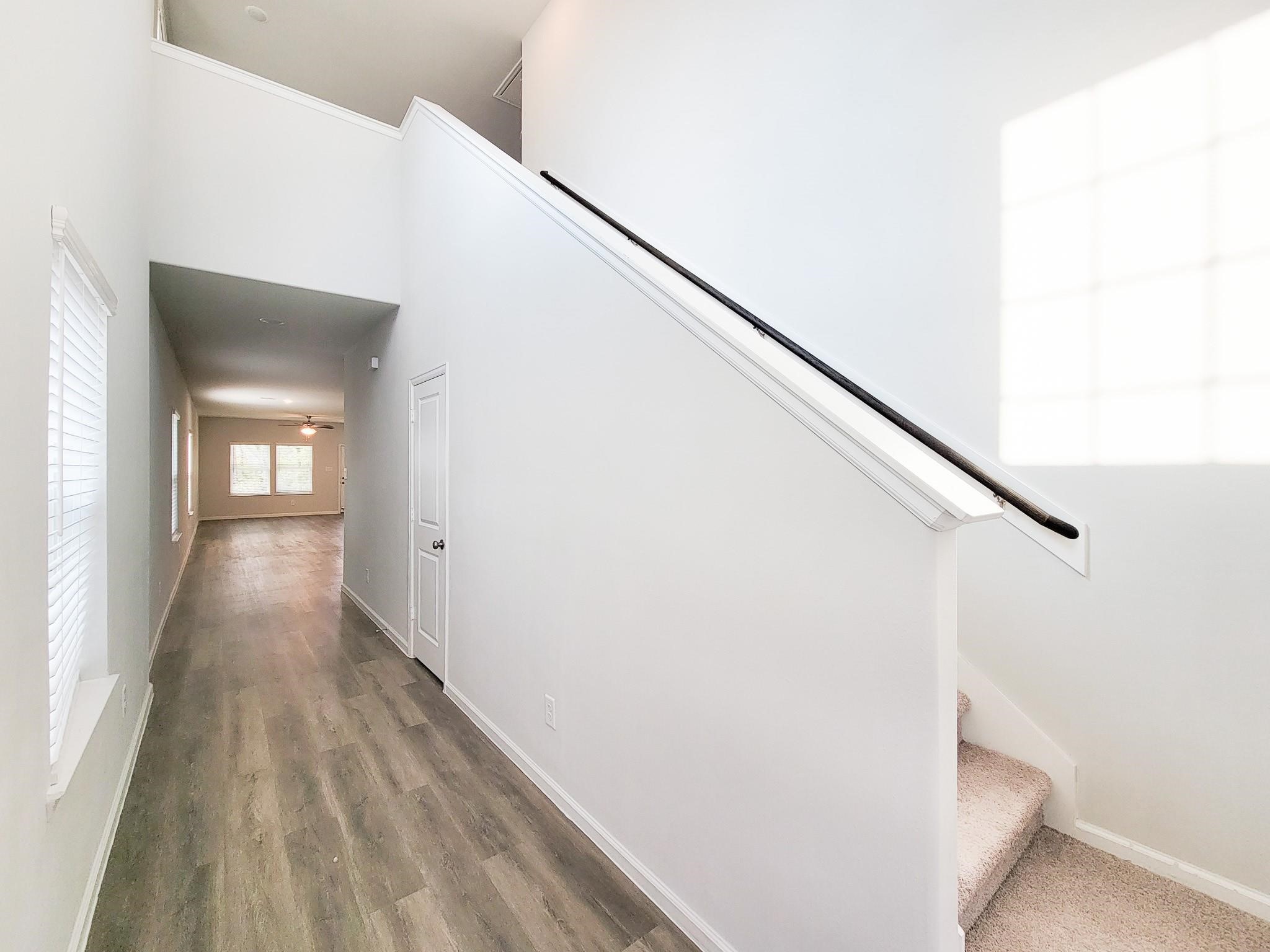 94 Valiant Ridge Trail Magnolia, TX 77354 - Photo 19 of 47 a view of a hallway with wooden floor and staircase