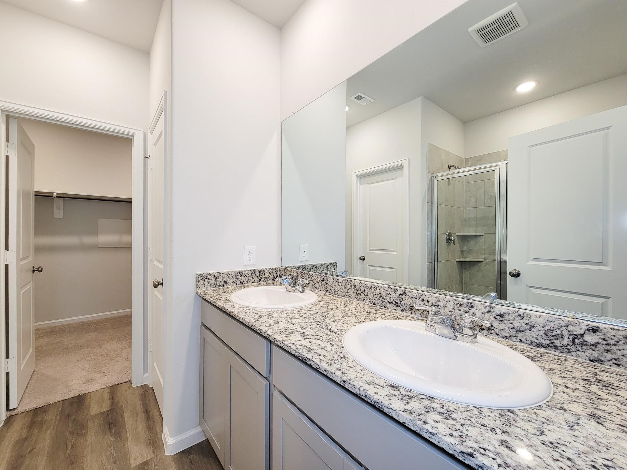 94 Valiant Ridge Trail Magnolia, TX 77354 - Photo 36 of 47 a bathroom with a granite countertop sink and a mirror