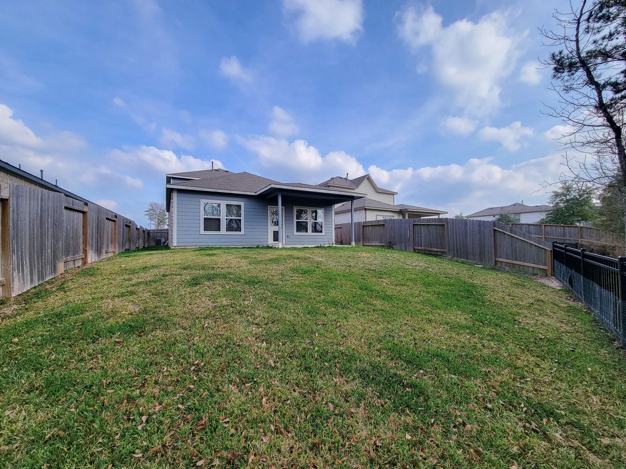 94 Valiant Ridge Trail Magnolia, TX 77354 - Photo 45 of 47 a view of a house with a back yard