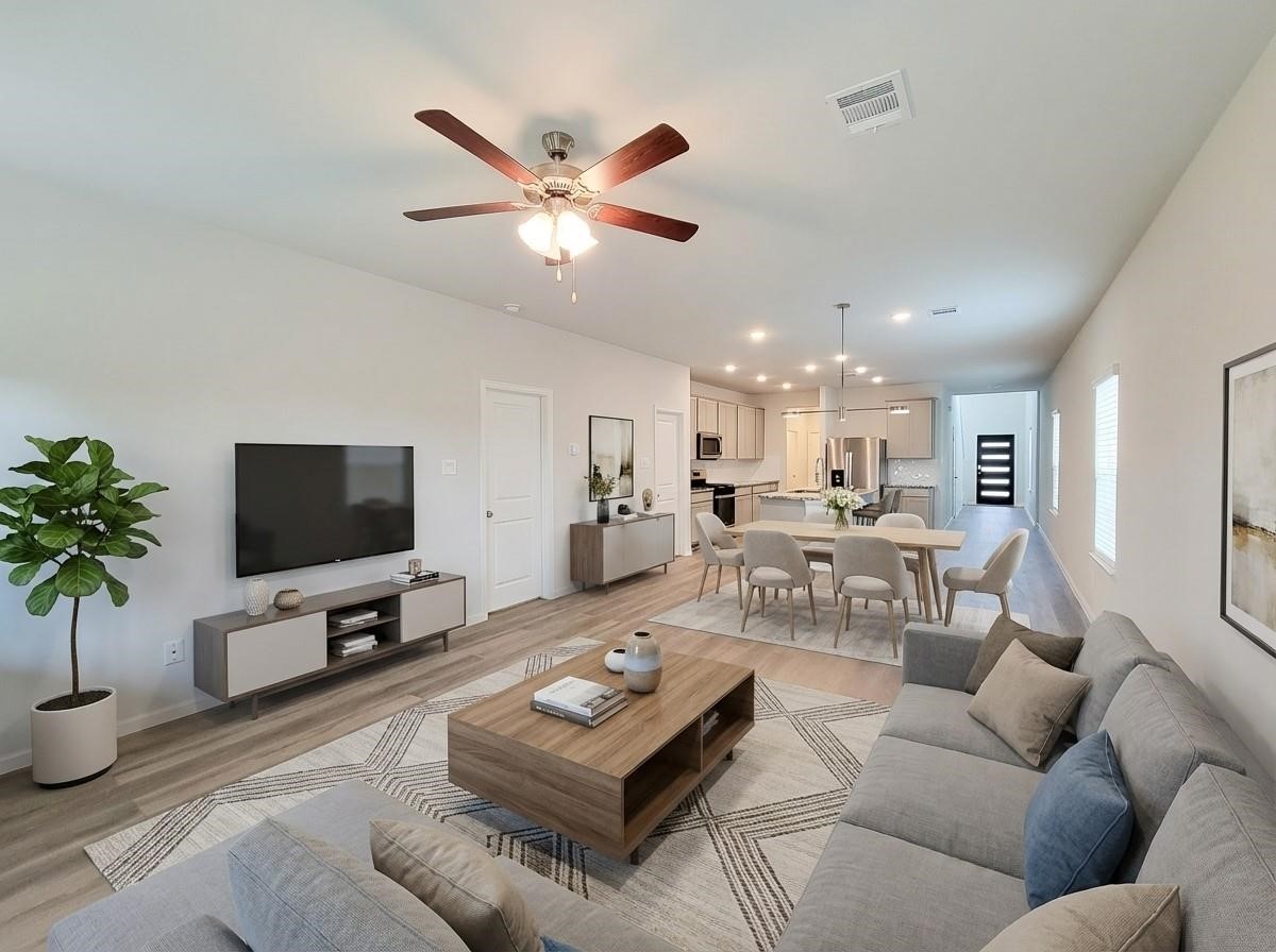 94 Valiant Ridge Trail Magnolia, TX 77354 - Photo 6 of 47 a living room with furniture and a flat screen tv