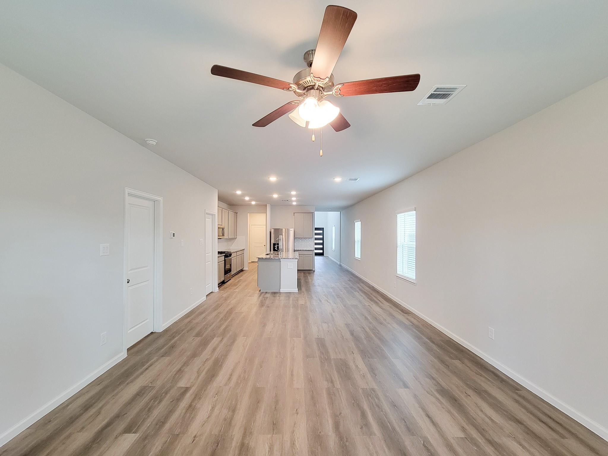 94 Valiant Ridge Trail Magnolia, TX 77354 - Photo 8 of 47 wooden floor in an empty room with a window