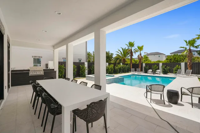 a view of a patio with swimming pool table and chairs