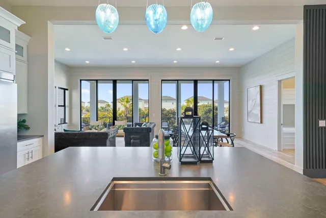 a view of kitchen with dining area and chandelier