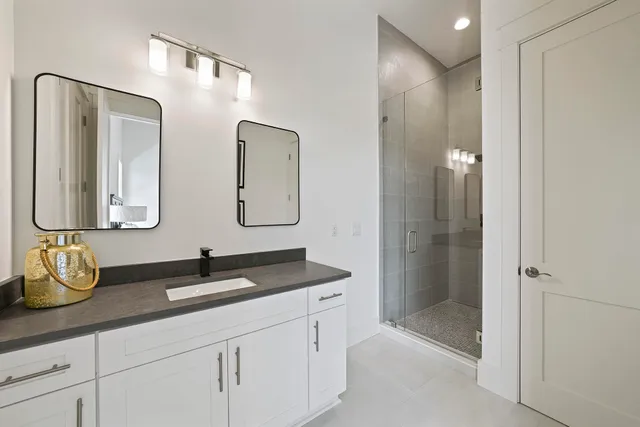 a bathroom with double vanity sink and mirror