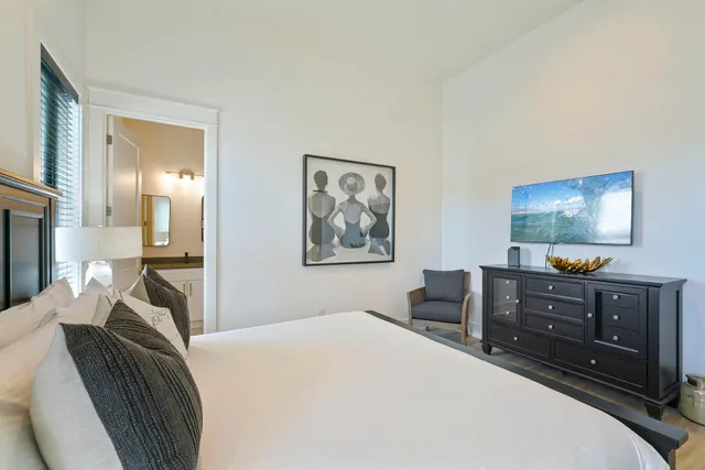 a bedroom with furniture and a flat screen tv