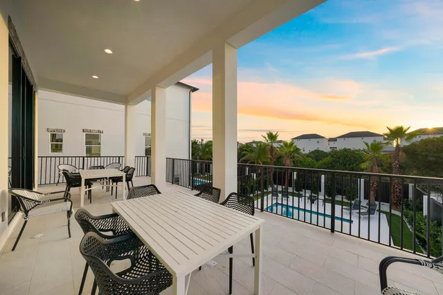a view of a balcony dining table and chairs