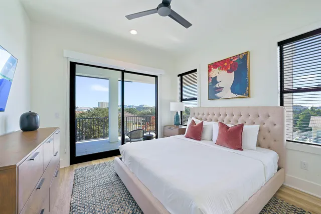 a bedroom with a large bed and a large window