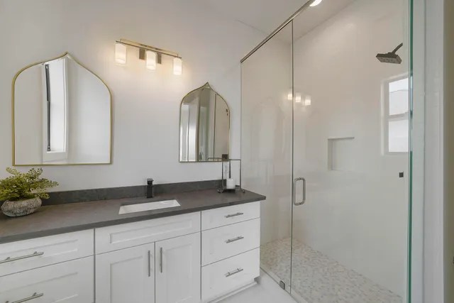 a bathroom with a double vanity sink and a mirror