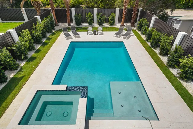 swimming pool view with a seating space