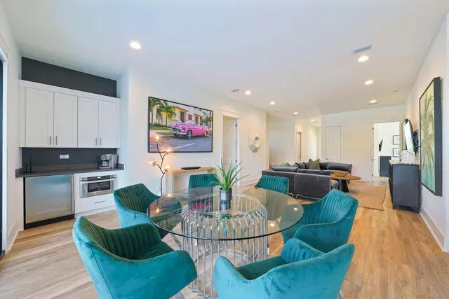 a living room with furniture and kitchen view