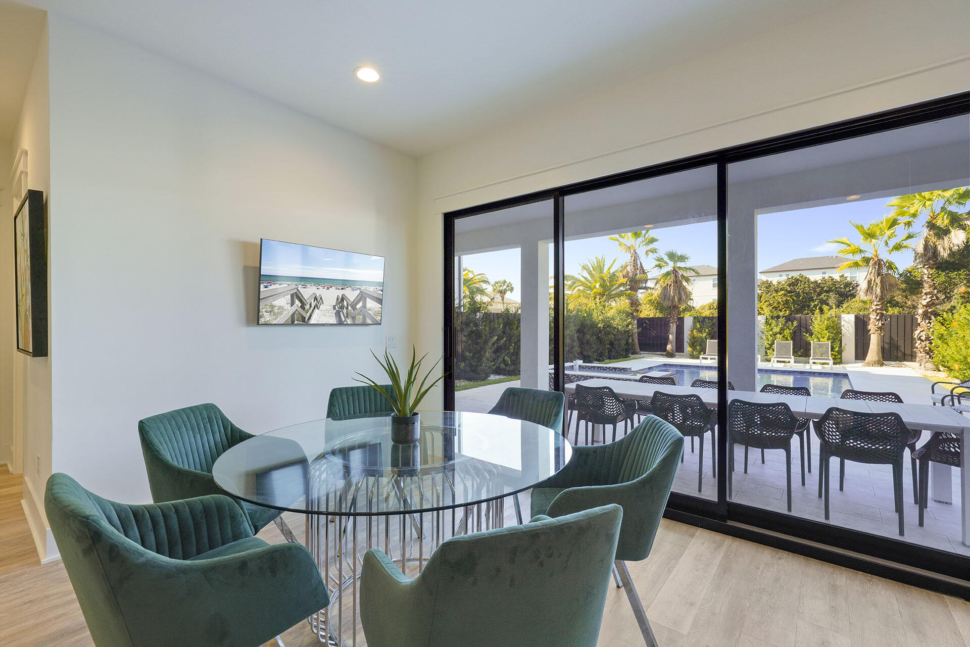 336 South Holiday Road Destin, FL 32550 - Photo 10 of 40 a dining room with furniture a flat screen tv and a floor to ceiling window