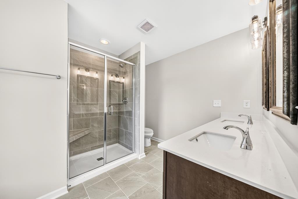 6 Liberty Place Fort Mitchell, AL 36856 - Photo 17 of 27 a bathroom with a shower sink and mirror