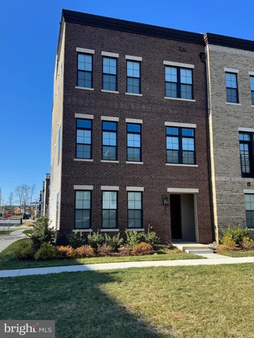 a front view of a building with a yard