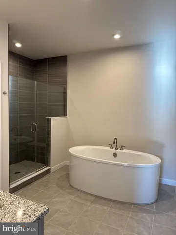 a white bath tub sitting next to a white sink