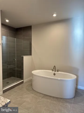 a white bath tub sitting next to a white sink