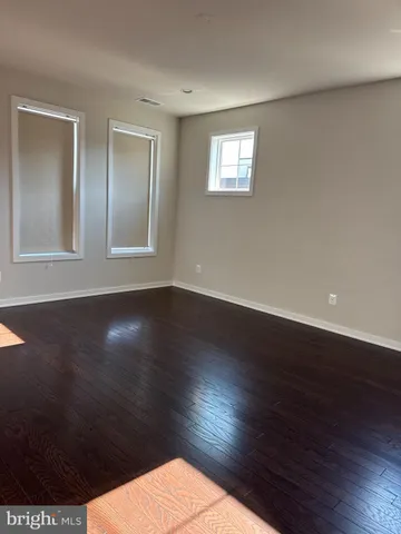 a view of wooden floor and windows in a room