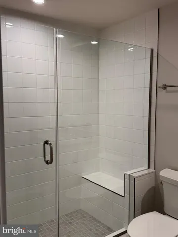 a bathroom with a shower a toilet and sink