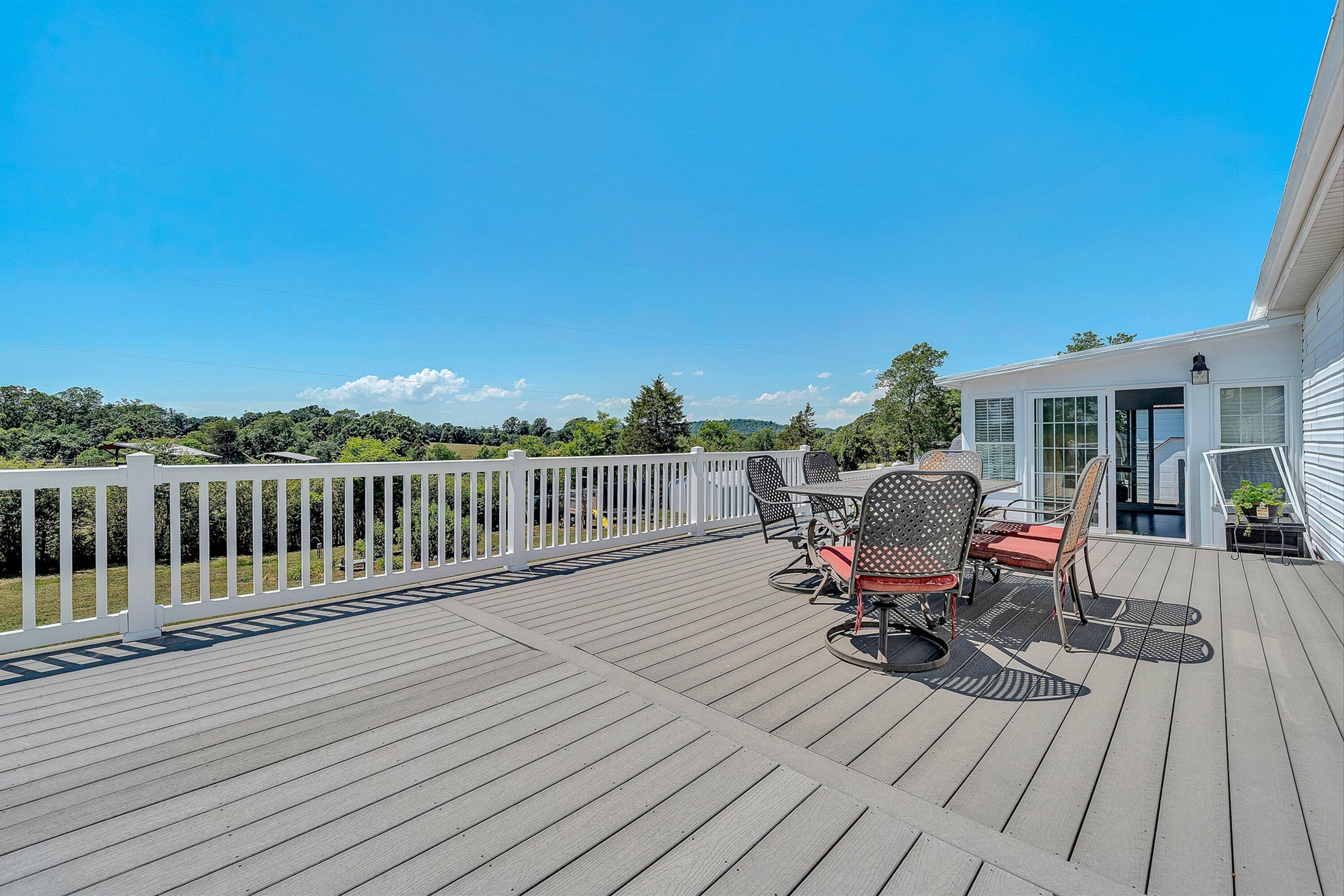 159 Simmons Creek Road Union Hall, VA 24176 - Photo 33 of 55 a view of deck with table and chairs and wooden floor