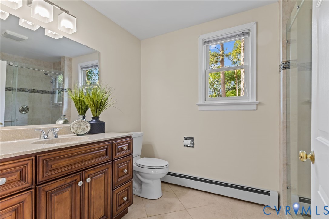 4804 Morrison Road Richmond, VA 23230 - Photo 25 of 48 a bathroom with a granite countertop sink a toilet and mirror