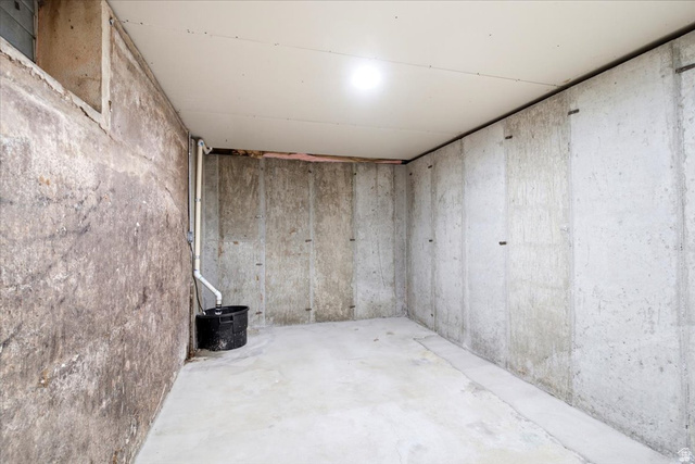 1341 29th Street Ogden, UT 84403 - Photo 27 of 37 Unfinished basement featuring poured concrete walls, a concrete floor, and a sump pump system